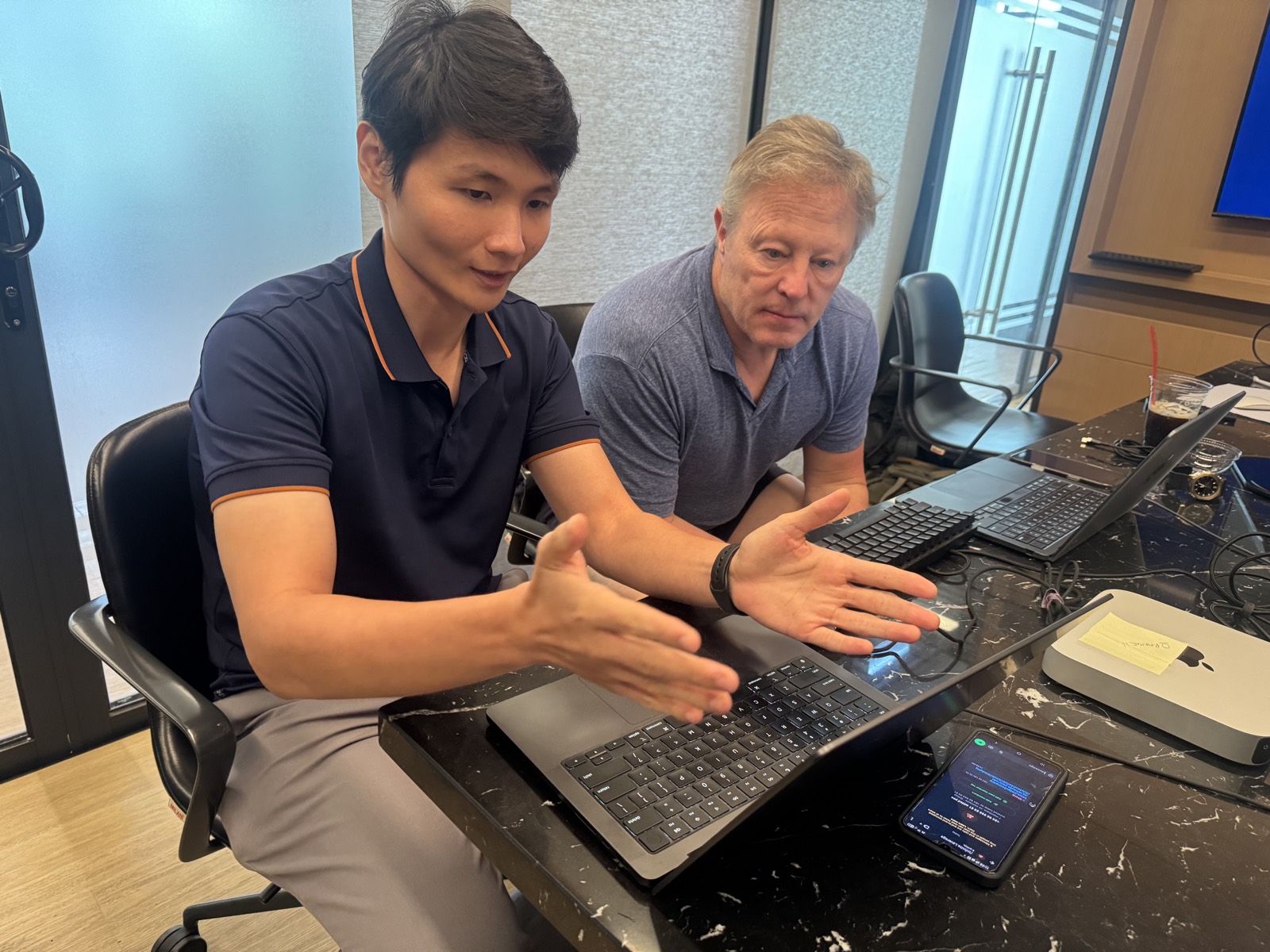 An engineer walking a guest through the build on a laptop