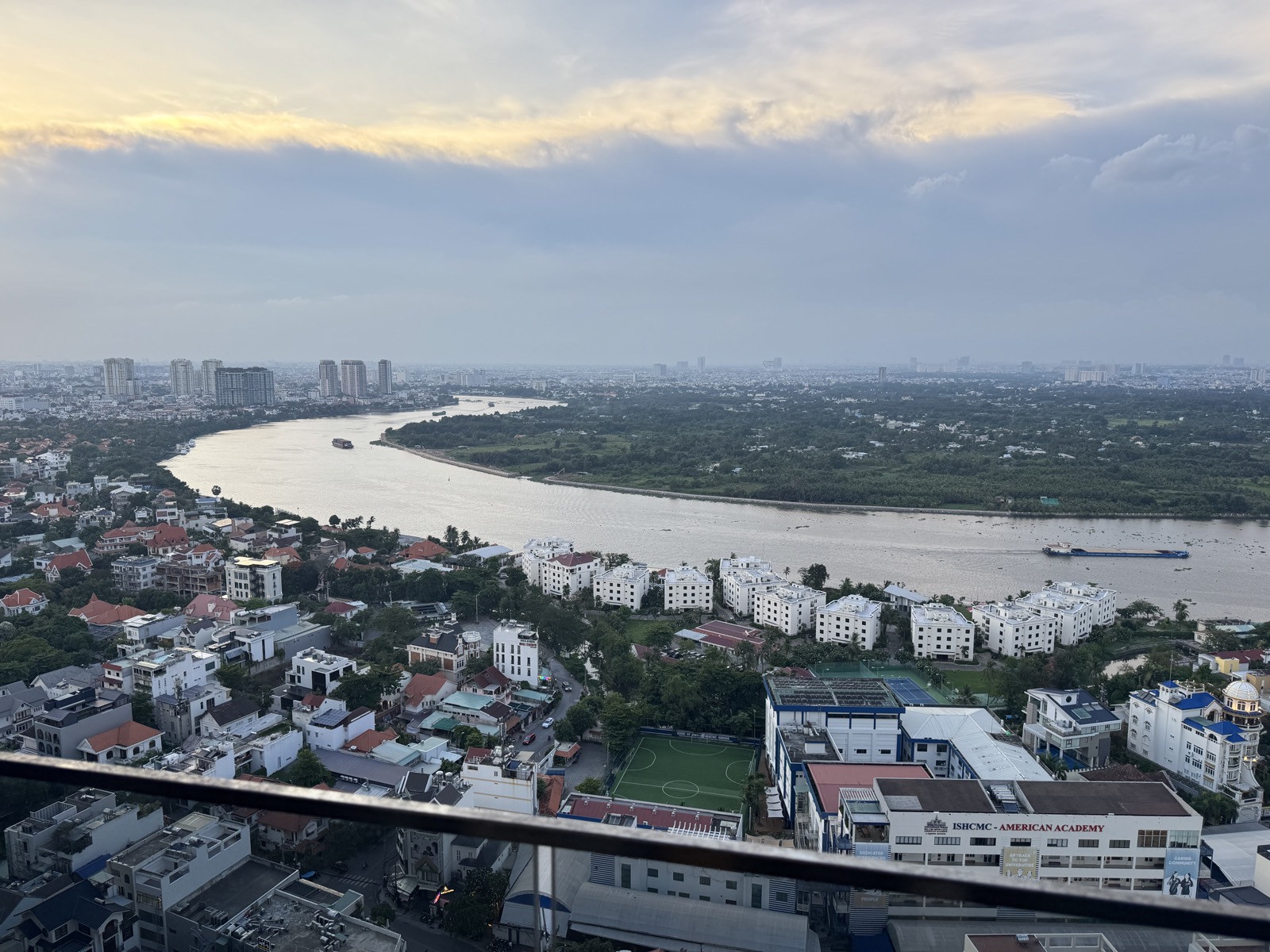 The Saigon river bending gold past Thao Dien at golden hour