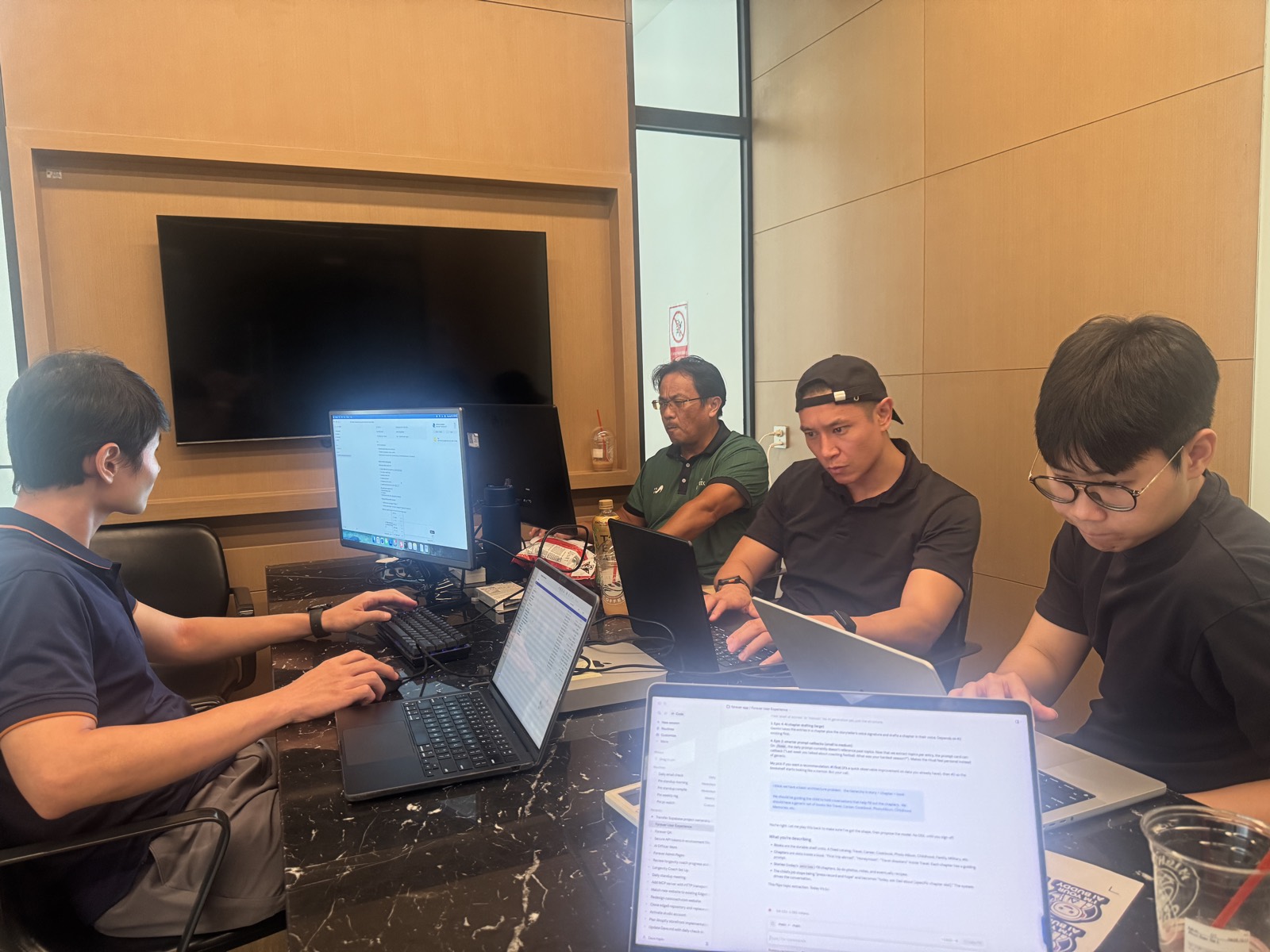 A small group heads-down at their laptops in a working session